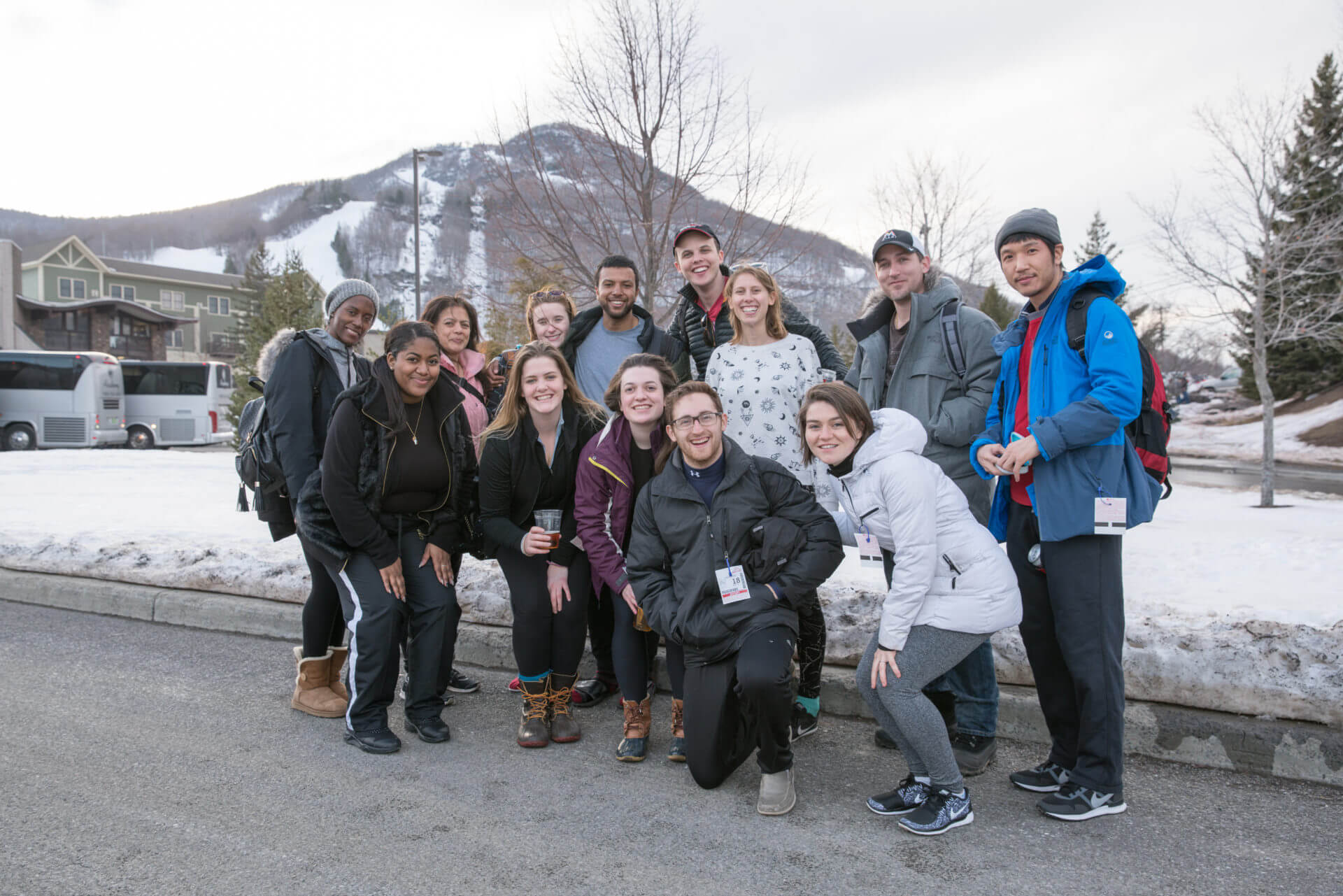 Group of individuals at Ollie social event in front of a snow covered mountain