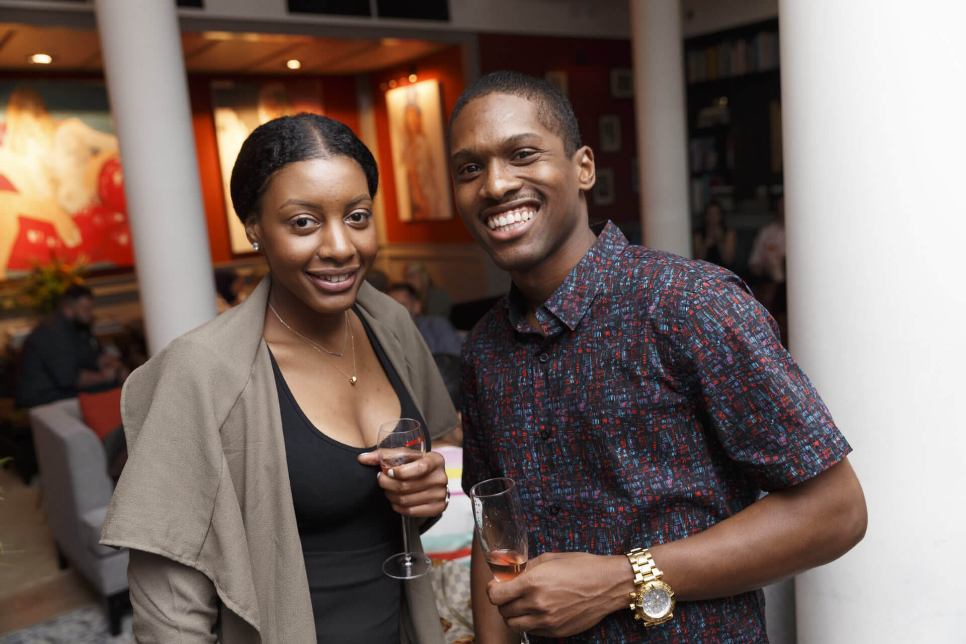 Two individuals at Ollie social event with drinks