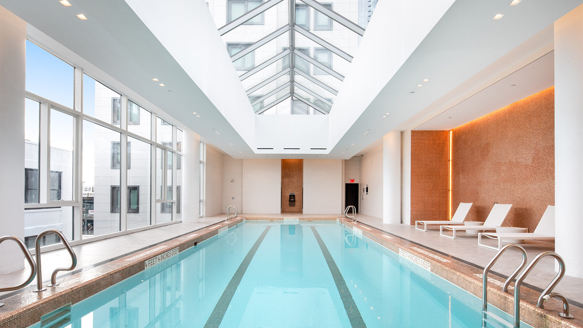Indoor pool and pool-side lounge chairs